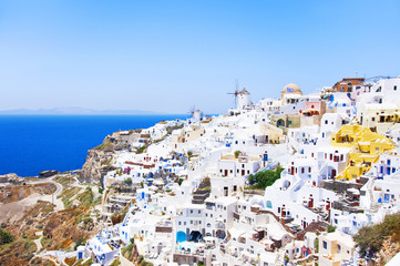View of the village of Oia, Santorini, Greece. Traditional Greek architecture, white houses, the Aegean Sea, the caldera. White architecture against the blue sea