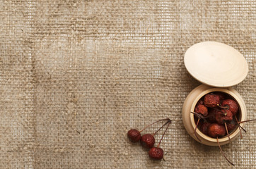 Herbal medicine. Alternative medicine concept. Dry organic natural ingridients. Scattered wild berry on white background with copy space.