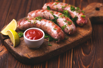 Grilled sausages with lime on iron grill pan