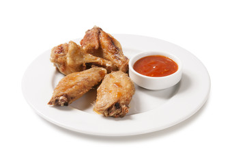 
fried chicken wings with sauce on a plate isolated on white
