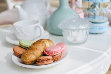 Breakfast by the window, two croissants, a cup of tea on a small table