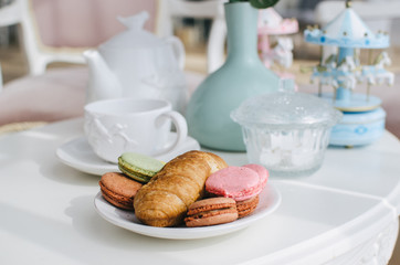Breakfast by the window, two croissants, a cup of tea on a small table