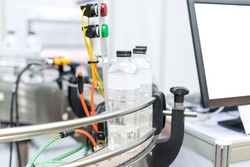 Water bottles on production line, process of bottling pure mineral water into bottles plastic