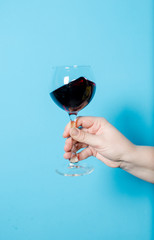 a glass of wine in a woman's hand. alcohol party.