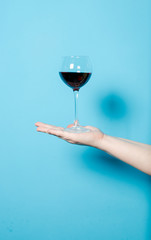 a glass of wine in a woman's hand. alcohol party.
