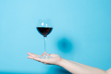 a glass of wine in a woman's hand. alcohol party.