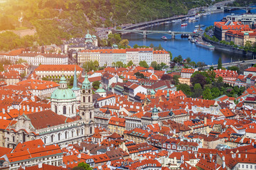 erial view of old Red Tiles roofs in the city Prague, Czech Republic, Europe. Beautiful day with blue sky with clouds in the town.