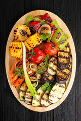 Grilled vegetables on black wooden background. top view 