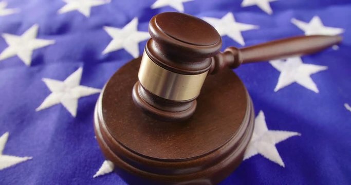 Closeup Of Gavel On American Flag At Table