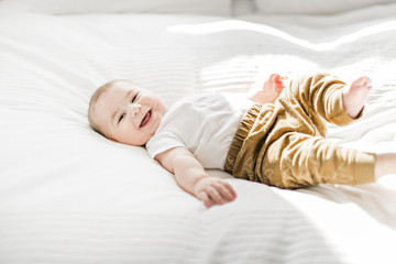Portrait of a baby boy on the bed in bedroom