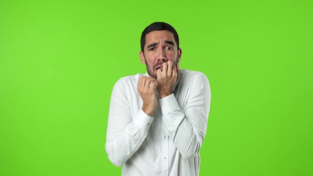 Nervous Young manon green background