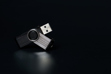 A flash drive on a black background with reflection.