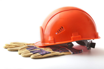 Orange hard hat, safety gloves on white background. Safety helmet.
