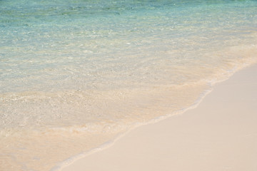 Fototapeta na wymiar clear water on clean white sand beach closeup