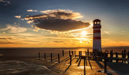 Cercles muraux Phare Lighthouse view during winter and dramatic sunset, Podersdorf am see, Austria
