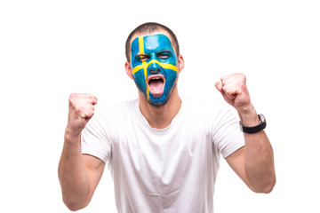 Handsome man supporter fan of Sweden national team with painted flag face get happy victory...