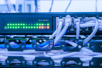The network switch is in the rack in the server room of the data center. Connected to the network...