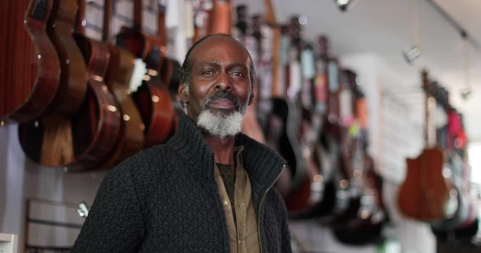 Portrait of a small business owner in a guitar store