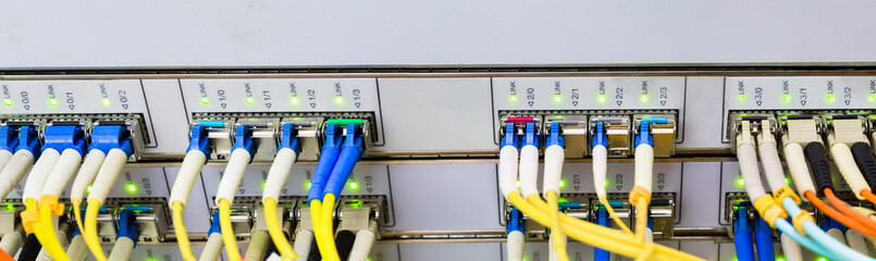 Panorama of optical links are on the central data center router.The front panel of the master...