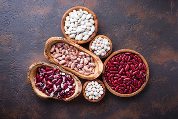 Assortment of various beans in wooden bowls 