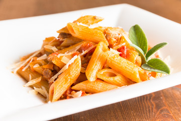 Mezze Penne al ragout e grana, Italian Pasta with meat sauce and grana cheese 