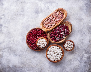 Assortment of various beans in wooden bowls 