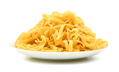 A portion of tagliatelle pasta in plate  isolated on white