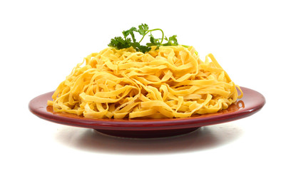 Egg noodles in plate on a white background