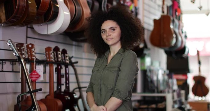 Portrait of a small business owner in a guitar store