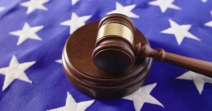 Lockdown Shot Of Gavel On American Flag At Table