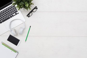 Office desk table with laptop, smartphone and supplies