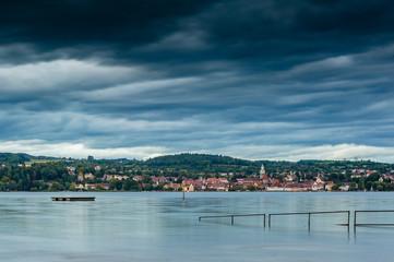 Naklejka premium A small citiy on the other shore of the lake