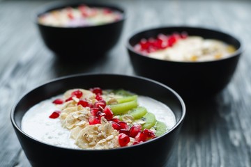 Delicious yoghurt smoothie bowls with assorted healthy fillings and fruit slices for dieting