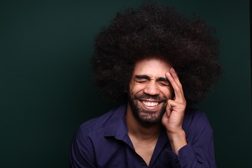 Afro man in front of a green background