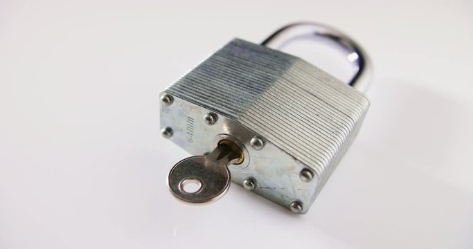 Locked Padlock And Key On Table Representing Cyber Security