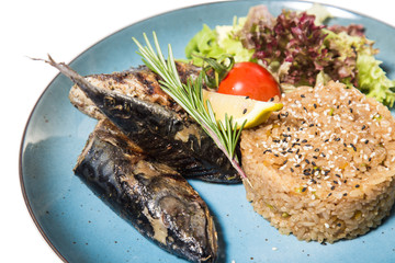 fried fish with garnish of rice isolated on white background