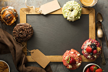 Variety of donuts around a chalkboard