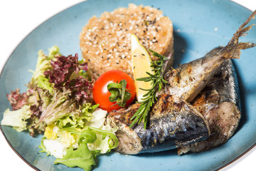 fried fish with garnish of rice isolated on white background