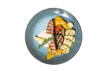 fried fish with garnish of vegetables isolated on white background