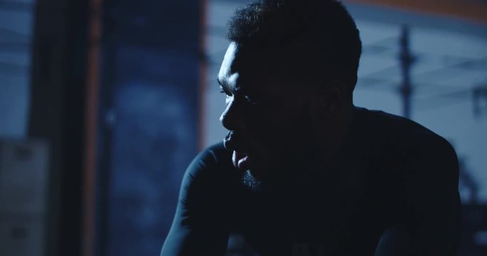 Slow Motion Shot Of Focused African-American Man In Sportswear Breathing Deep Trying To Recover After Heavy Workout.