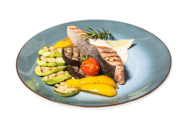 fried fish with garnish of vegetables isolated on white background