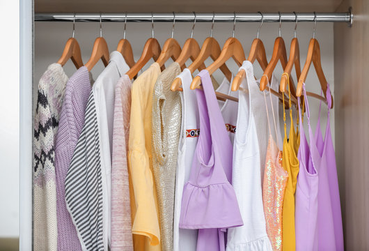 Different clothes on hangers in closet