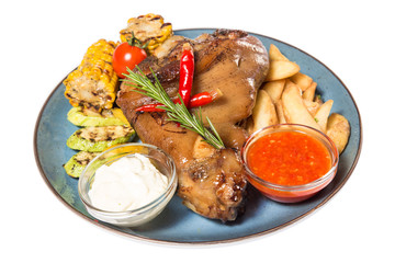 a large piece of meat with corn and potatoes