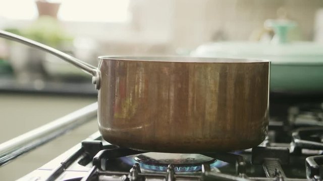 Steam Blowing From Container On Stove In Kitchen