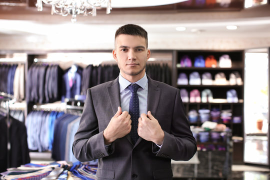 Young man wearing elegant suit in boutique