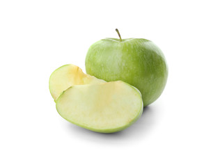 Slices of fresh green apple and whole fruit isolated on white