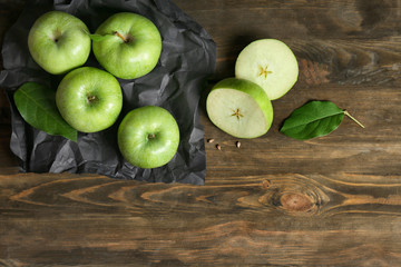 Fresh green apples on wooden background, top view