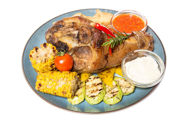 a large piece of meat with corn and potatoes