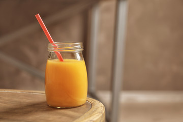 Jar of orange juice on wooden table
