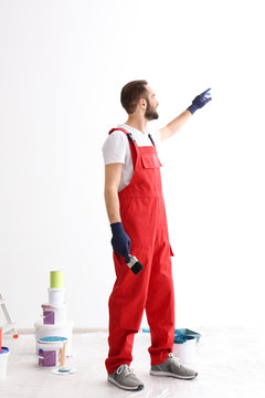 Portrait of male decorator with brush indoors
